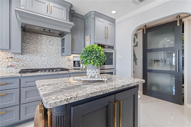 kitchen with gray cabinets, backsplash, crown molding, and stainless steel appliances