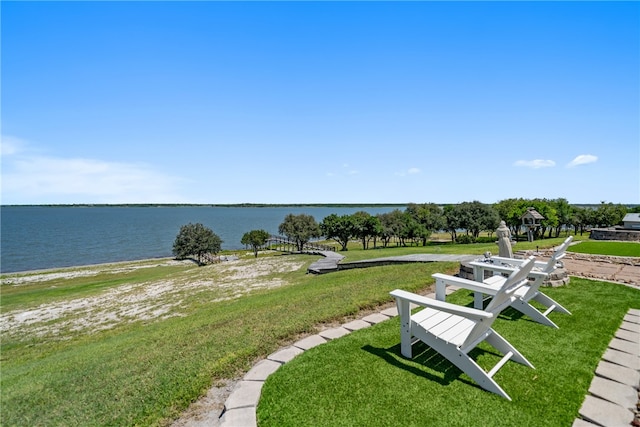 surrounding community featuring a yard and a water view