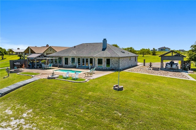 back of property with a lawn, a patio, and a gazebo