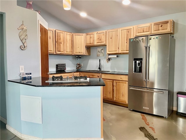 kitchen featuring lofted ceiling, sink, high quality fridge, and kitchen peninsula