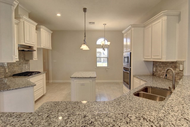 kitchen featuring white cabinetry, extractor fan, sink, appliances with stainless steel finishes, and pendant lighting