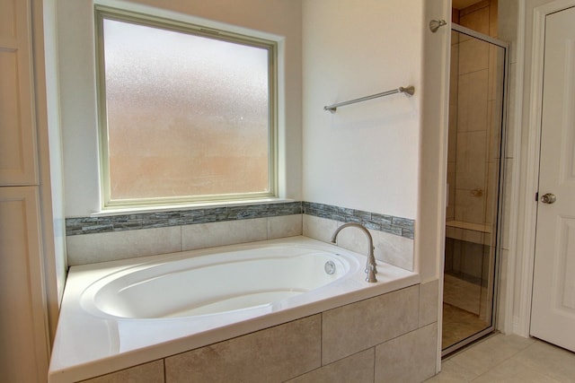 bathroom with tile patterned flooring and separate shower and tub