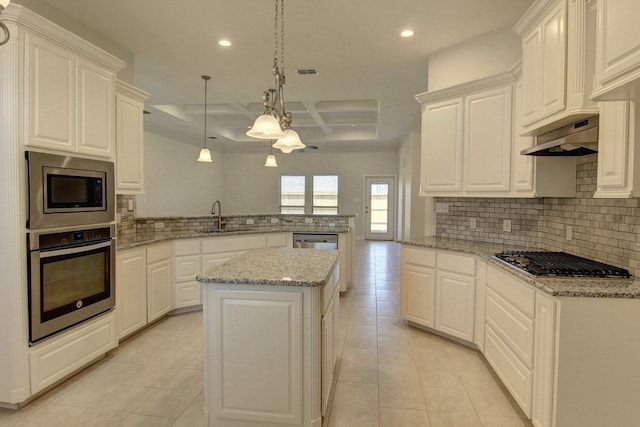 kitchen with stainless steel appliances, light tile patterned floors, pendant lighting, sink, and kitchen peninsula