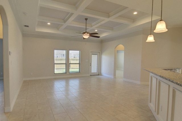 tiled empty room featuring coffered ceiling, ceiling fan, and beamed ceiling