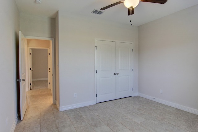 unfurnished bedroom featuring a closet, light tile patterned floors, and ceiling fan