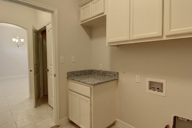 laundry area featuring gas dryer hookup, light tile patterned flooring, washer hookup, cabinets, and an inviting chandelier