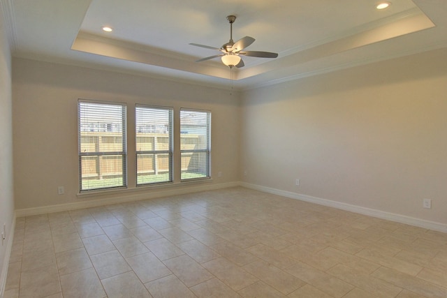 spare room featuring ceiling fan, crown molding, and a tray ceiling