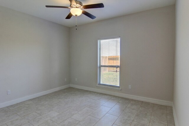 spare room featuring light tile patterned flooring and ceiling fan