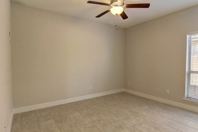 tiled empty room featuring ceiling fan