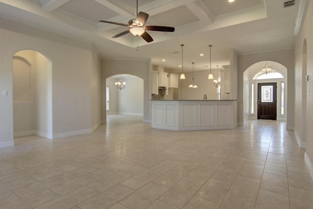 unfurnished living room featuring ceiling fan with notable chandelier, light tile patterned floors, coffered ceiling, beamed ceiling, and crown molding