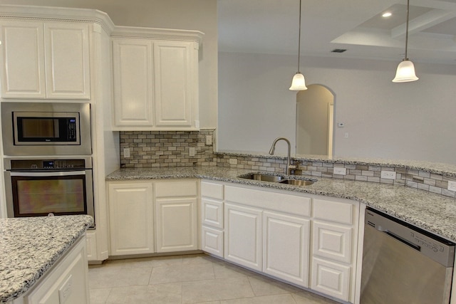 kitchen featuring stainless steel appliances, hanging light fixtures, light tile patterned floors, and sink