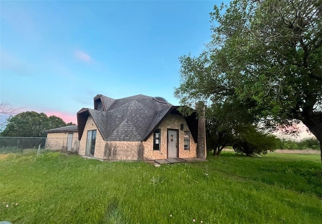 view of front of home with a lawn