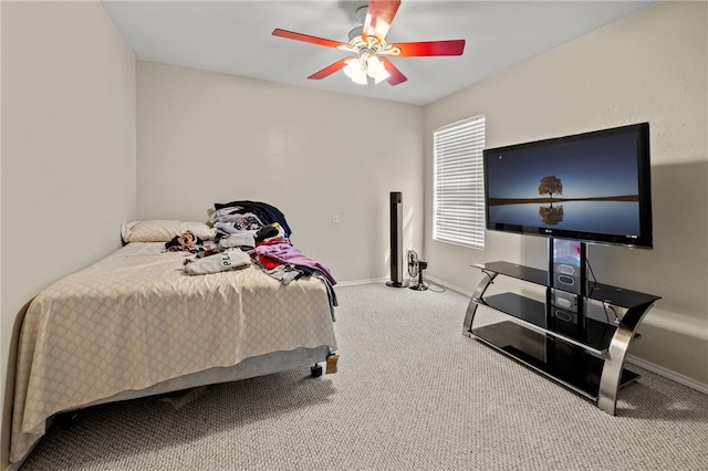 carpeted bedroom featuring a ceiling fan and baseboards