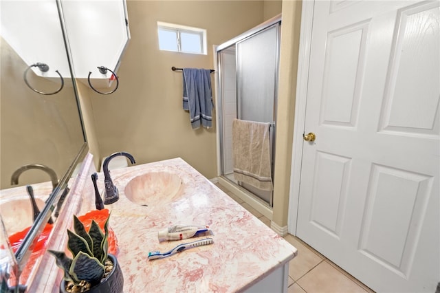 bathroom featuring a stall shower, vanity, and tile patterned floors