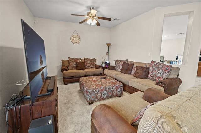 living room with carpet floors, visible vents, and ceiling fan