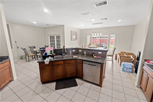 kitchen with visible vents, dishwasher, a sink, and light tile patterned floors