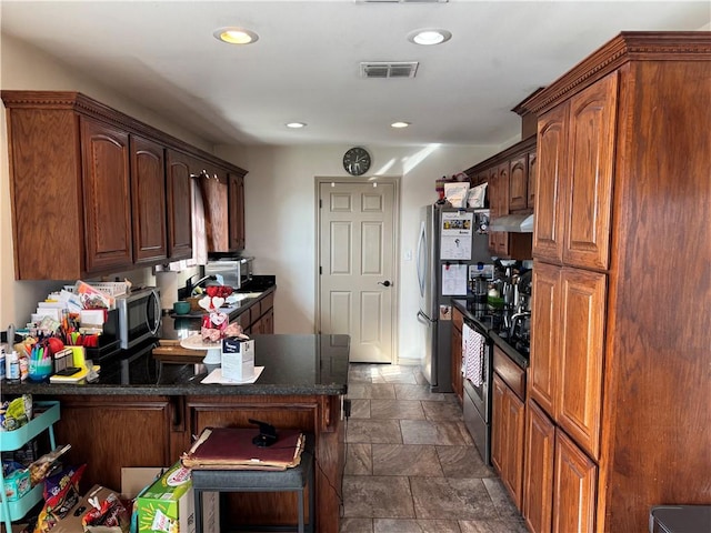 kitchen featuring kitchen peninsula, exhaust hood, and stainless steel appliances