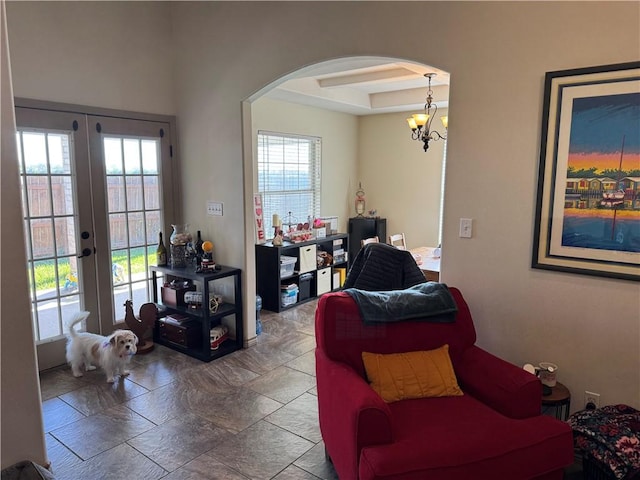 interior space with beamed ceiling, a wealth of natural light, french doors, and a chandelier