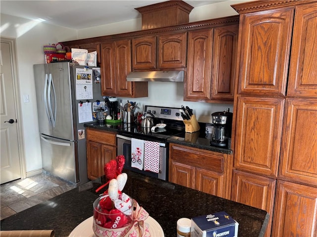 kitchen featuring stainless steel appliances and dark stone counters