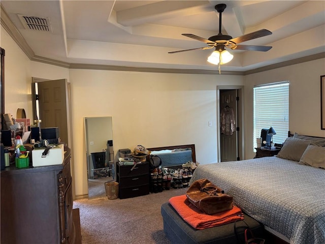 carpeted bedroom featuring ceiling fan, crown molding, and a raised ceiling