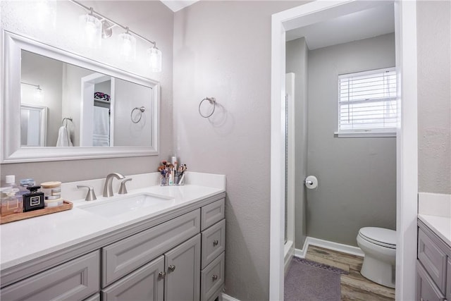 3346 Samoa Dr, Corpus Christi, TX 78418 - bathroom featuring vanity, wood finished floors, toilet, baseboards, and a shower