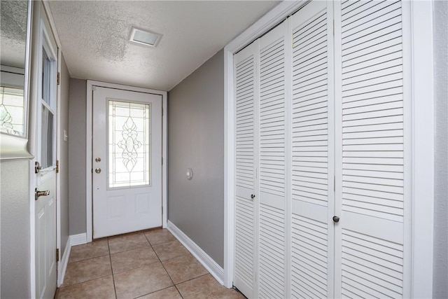 3346 Samoa Dr, Corpus Christi, TX 78418 - entrance foyer featuring baseboards, a textured ceiling, and light tile patterned flooring