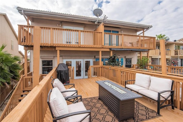 wooden terrace featuring french doors and an outdoor living space