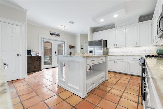 kitchen with visible vents, appliances with stainless steel finishes, tasteful backsplash, and french doors