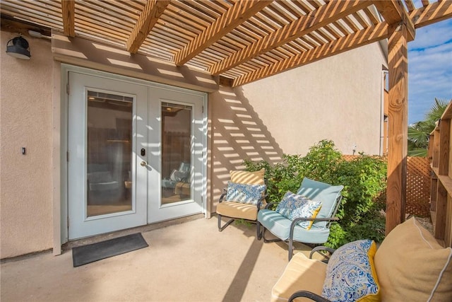 exterior space with stucco siding, a patio area, a pergola, and french doors