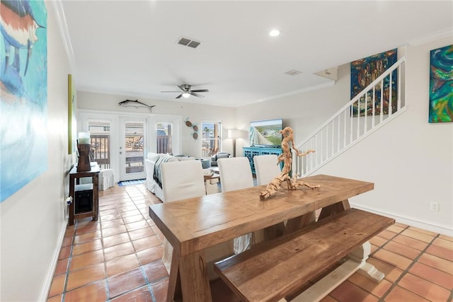 dining room featuring light tile patterned flooring, stairs, visible vents, and ornamental molding