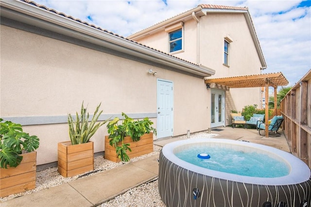 back of house with a patio, fence, french doors, a pergola, and stucco siding