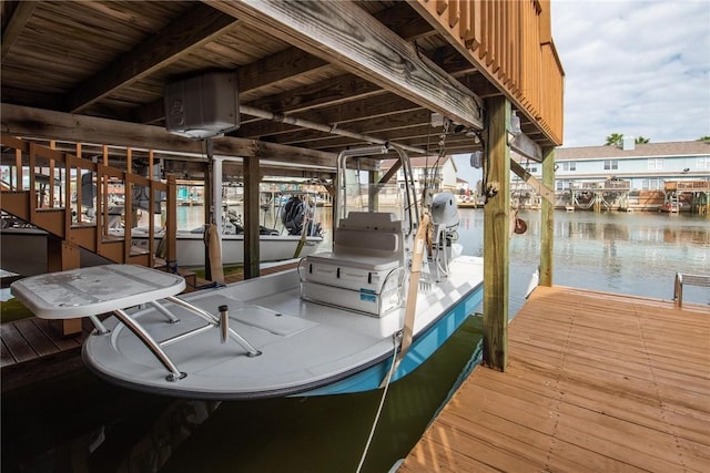 dock area with a water view and boat lift