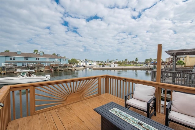 dock area featuring a deck with water view