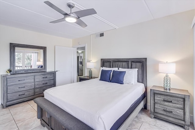 bedroom with ceiling fan and light tile patterned floors