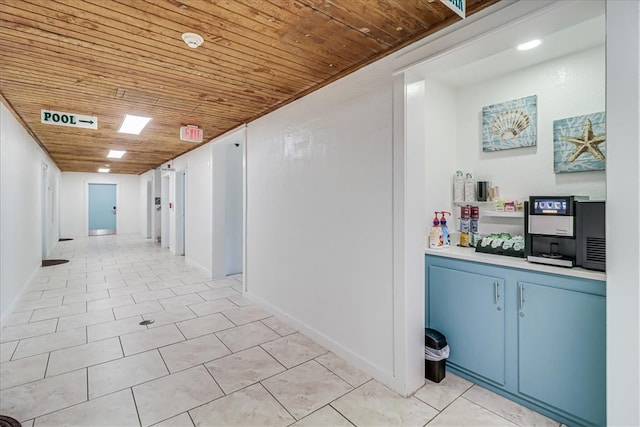 hall with wooden ceiling and light tile patterned floors