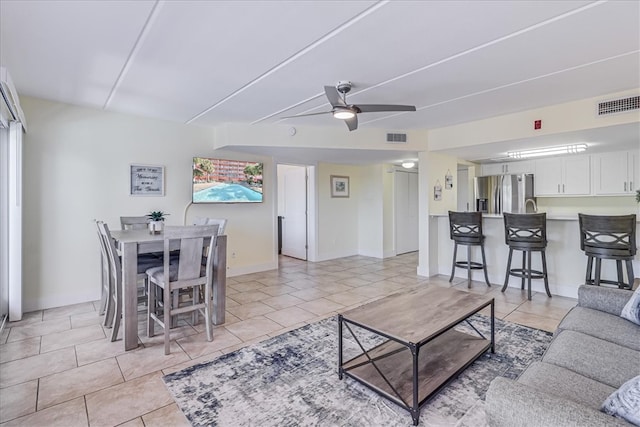 tiled living room featuring ceiling fan