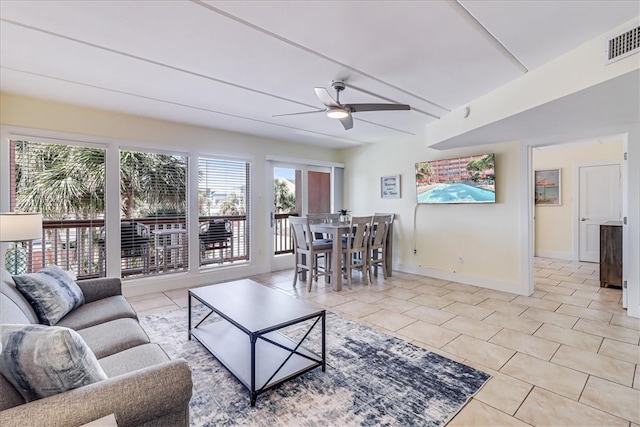 living room with ceiling fan and light tile patterned flooring