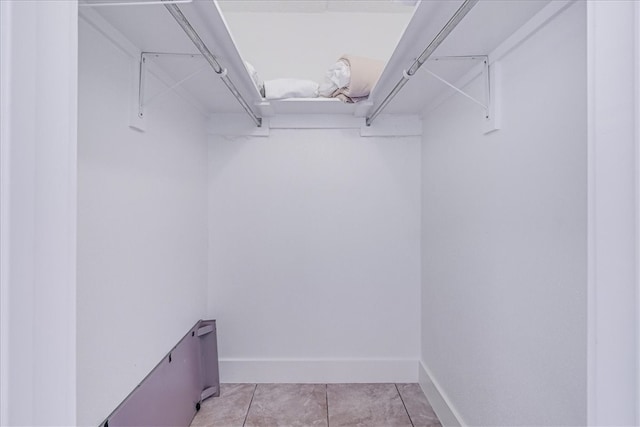 spacious closet featuring light tile patterned flooring