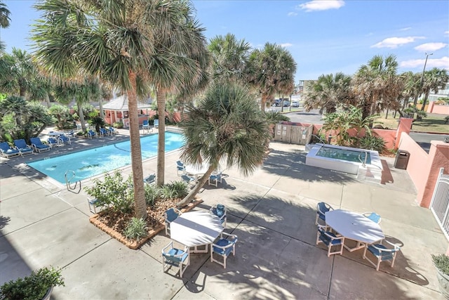 view of pool featuring a patio and a hot tub