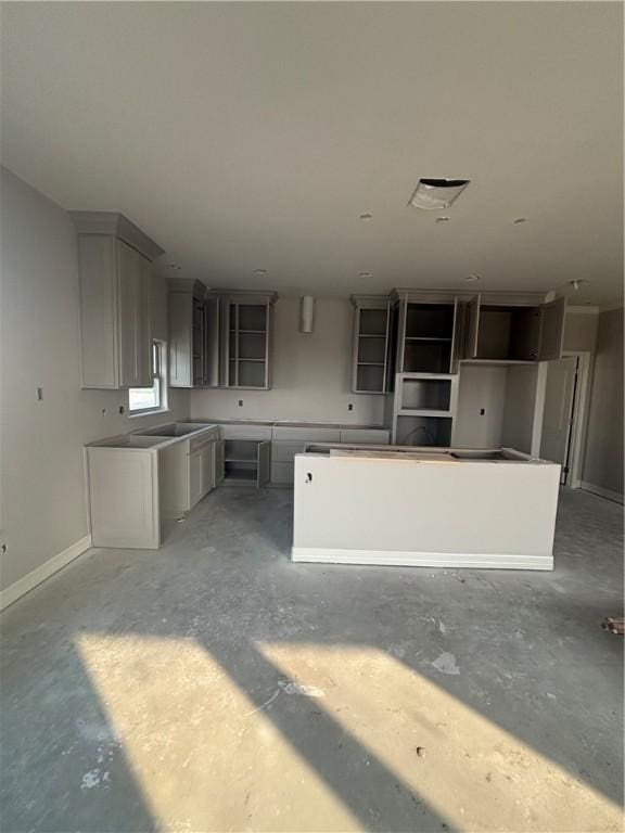 3102 Adak Ct, Corpus Christi, TX 78414 - kitchen featuring concrete flooring, a kitchen island, and baseboards
