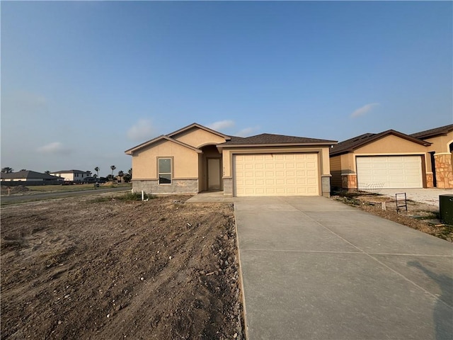 3102 Adak Ct, Corpus Christi, TX 78414 - ranch-style house featuring stucco siding, an attached garage, concrete driveway, and stone siding