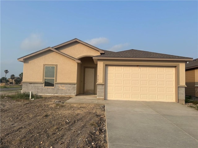3102 Adak Ct, Corpus Christi, TX 78414 - ranch-style house with stucco siding, driveway, and an attached garage