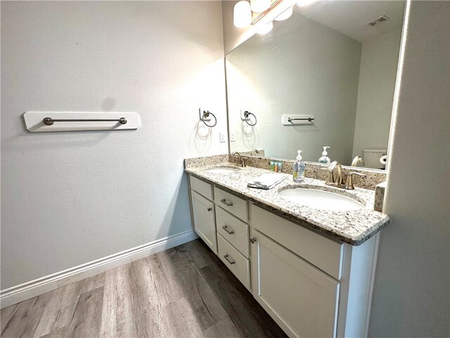 bathroom featuring hardwood / wood-style floors, vanity, and toilet