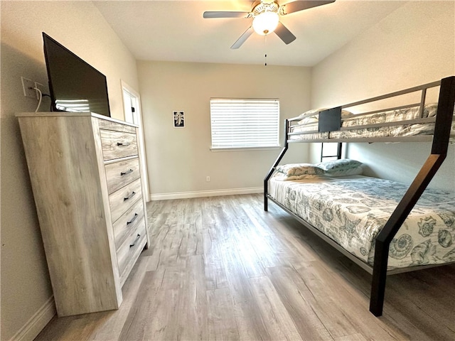 bedroom with ceiling fan and light hardwood / wood-style flooring