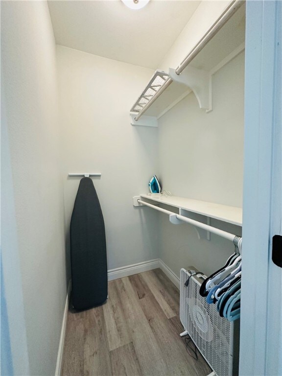 spacious closet featuring light wood-type flooring