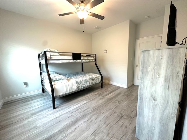 bedroom with light hardwood / wood-style floors and ceiling fan