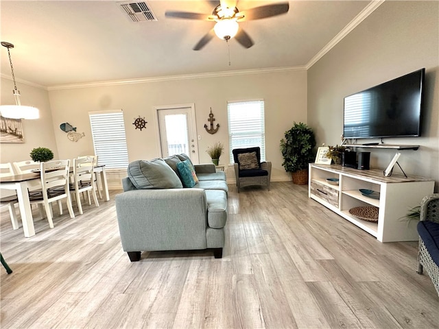 living room with ceiling fan, light wood-type flooring, and crown molding