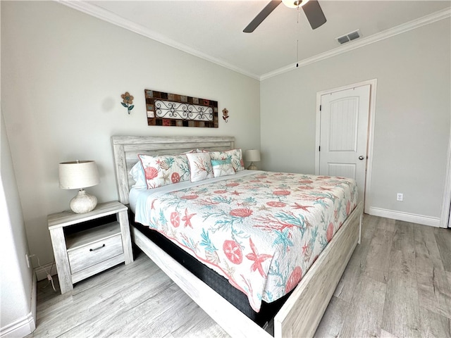 bedroom with ornamental molding, ceiling fan, and light hardwood / wood-style flooring