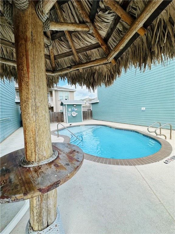 view of swimming pool with a patio and a gazebo