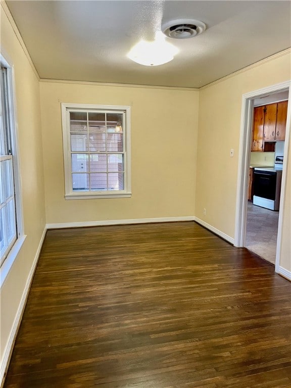 unfurnished room featuring a wealth of natural light and dark hardwood / wood-style floors